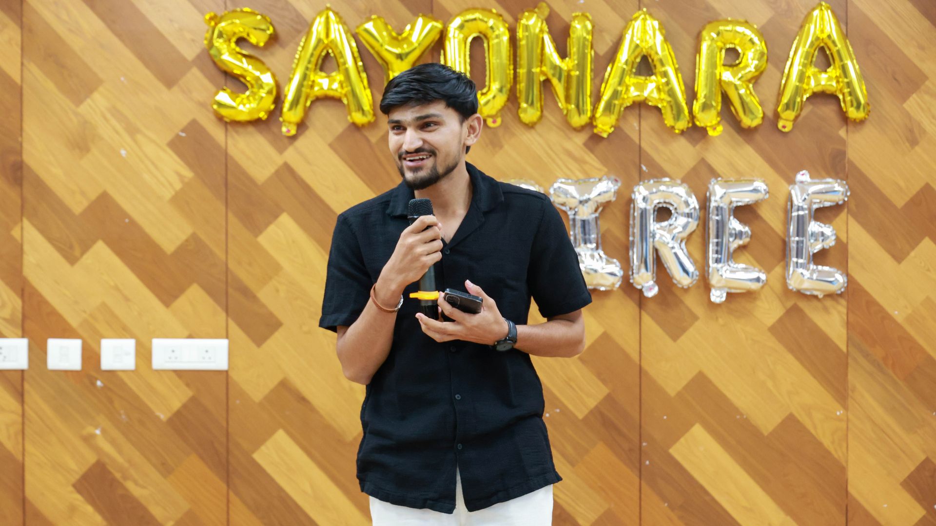 Aditya Sathawane delivering a storytelling performance on stage during a college creative event.